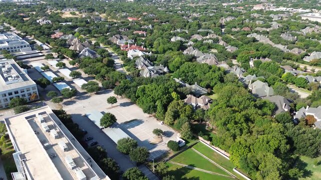 Covered carport parking links corporate facilities along Dallas Parkway. Lush green lawns buffer luxury Starwood rooftops, displaying balanced suburban commercial expansion across Frisco, Texas