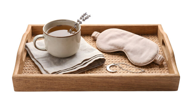 Sleep concept with herbal tea cup, eye mask on wooden tray isolated on transparent background