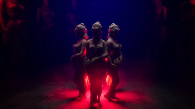 3D Render of Circle of Female Statues Illuminated by Blue Spotlight and Red Floor Glow