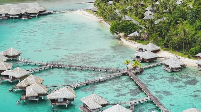 Aerial view of luxury overwater bungalows on tropical island resort at Bora Bora.