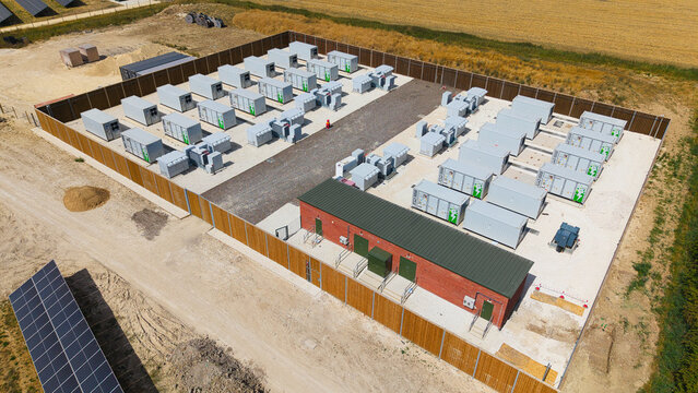 Aerial view of Bicker Fenn Solar farm and Battery Storage BESS with rows of energy storage containers and a brick control building in Boston, England, United Kingdom.