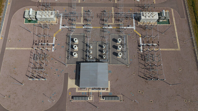 Aerial view of the Triton Knoll offshore windfarm 400220kV substation, featuring electrical transformers, switchgear, and cooling units in Boston, England, United Kingdom.