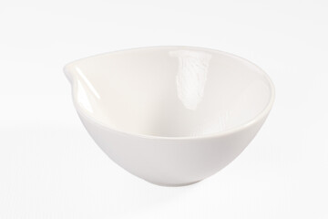 White ceramic bowl with pouring spout on clean background