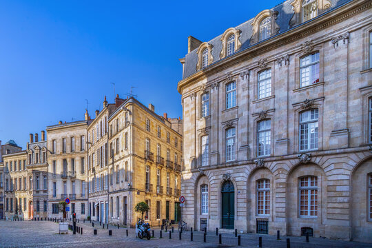 Historical classic buildings with elegant facades on a public square in Bordeaux, France. Sunny daylight view of old town