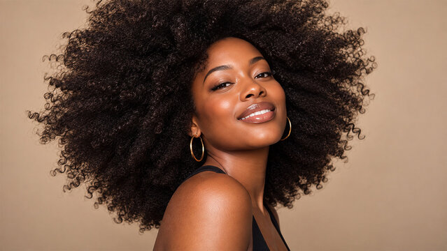Beautiful Black woman with voluminous natural afro hair posing confidently, elegant beauty portrait celebrating curls, healthy hair and natural hairstyle