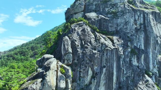 Aerial 4K view of majestic rocky cliffs and peaks in Dootasan Mountain, Donghae, South Korea