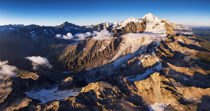 Mount Tetnuldi with glacier at sunset rises above the Great Caucasian mountain landscape Range in the upper Svaneti. Georgia. Travel