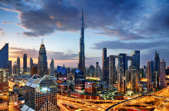 Dubai modern skyline  architecture by night with illuminated skyscrapers, United Arab Emirates