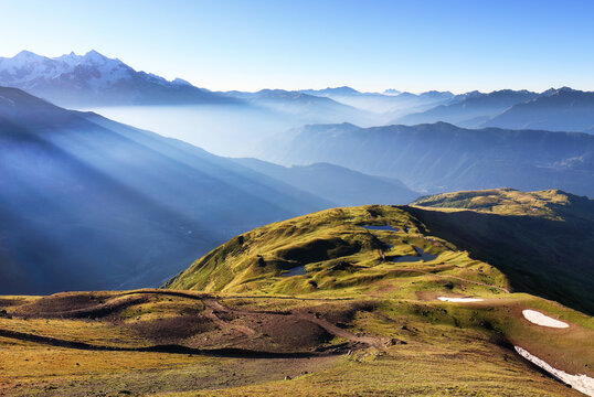 Sunrise on mountain lake Koruldi. Landcape with mountain and sunlight - sun rays. Upper Svaneti, Georgia Europe. Caucasus mountains.
