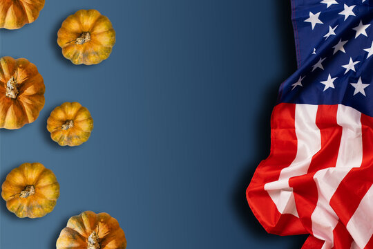 Group of pumpkins and American flag. Autumn season time