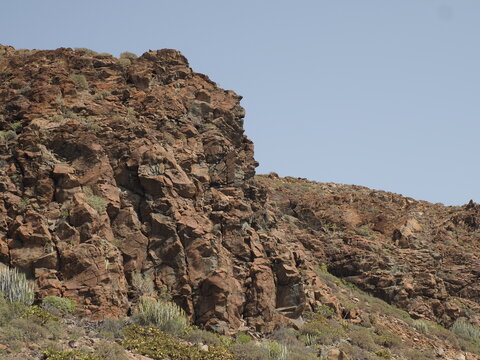 Close up of brown volcanic rock formation on a dry mountain side