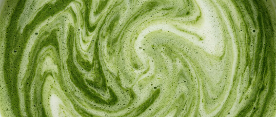 Obraz premium Matcha Latte Milk Texture Background, Creamy Green Tea Liquid with Natural Swirls