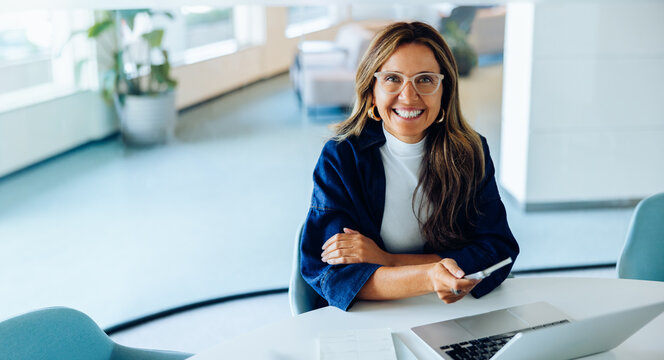 Female professional at laptop in office space