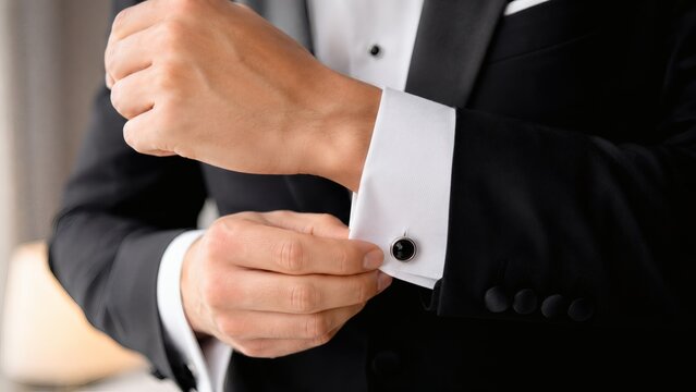 Businessman adjusting cufflinks in elegant close-up
