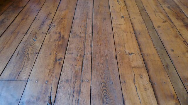 Aston Hall oak floorboards seen from a low forward walking camera, revealing worn timber planks and patina inside the Jacobean manor house in Birmingham, England.