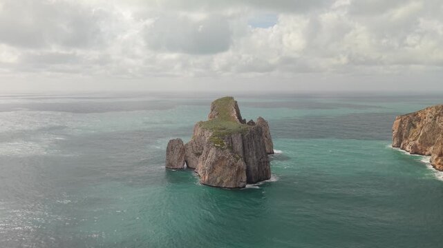 Massive Limestone Sea Stack Pan di Zucchero Near Masua In The Sulcis-Iglesiente Region Of Southwestern Sardinia, Italy. Aerial Drone Shot