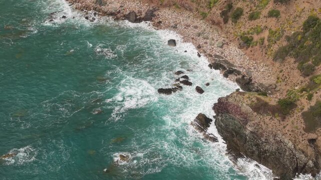 Foamy Waves Crash Against The Rocky Coastline Of Masua In Southwestern Sardinia, Italy. High-angle Shot
