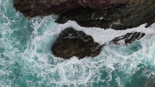 Above Rough Waves Crashing Along The Mediterranean Coast Near Masua In The Sulcis-Iglesiente, Southwestern Sardinia, Italy. Aerial top-down Shot