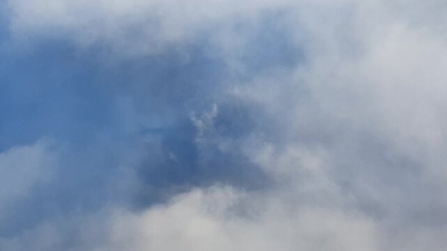 Airplane flying through clouds casting a glory shadow effect seen from above.