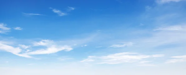 Clear blue sky with wispy white clouds drifting gently © lovelyday12