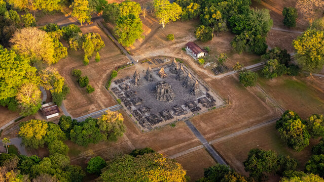 Aerial view of Plaosan Temple complex surrounded by lush green trees and manicured lawns in Yogyakarta, Special Region of Yogyakarta, Indonesia.