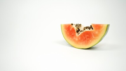 Fresh ripe papaya wedge slice with black seeds isolated on plain white background © Liada