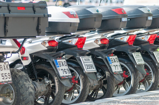  A row of parked scooters available for hire on the Greek island of Skiathos, a popular tourist destination in the Aegean Sea.