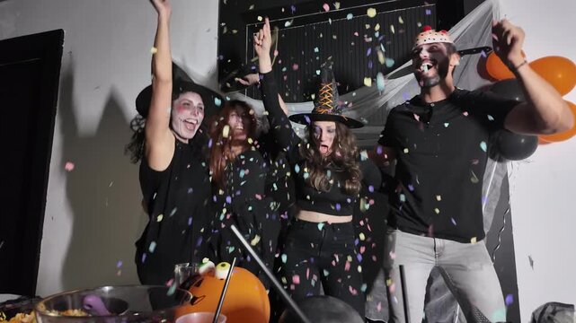 Friends throwing confetti at Halloween party
