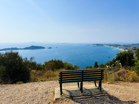 Scenic coastal view with bench overlooking the Ionian Sea in Corfu, Greece