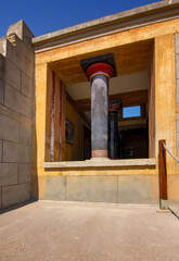 Naklejka premium A restored Minoan column framed by a stone window opening at the Palace of Knossos on Crete.