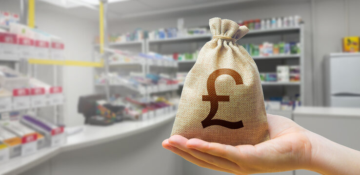 pound sterling money bag on the background of a pharmacy with medical supplies