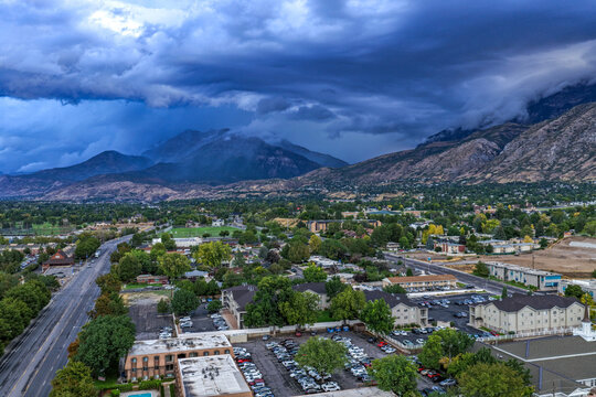 Aerial view of the urban landscape of Provo and Orem with a dramatic thunderstorm rolling over the Wasatch Front mountains in Utah Valley, Provo, Utah, United States.
