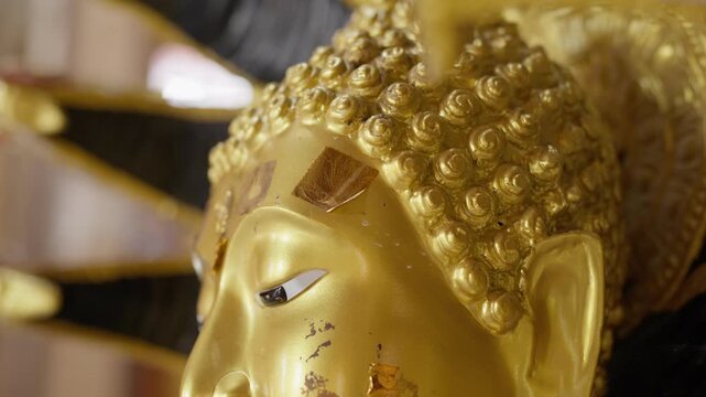 Numerous golden Buddha statues inside a serene temple hall. High-detail 4K B-roll shot showing Thai Buddhist culture, religion, and spiritual art.
