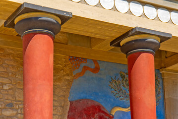 Naklejka premium Reconstructed Minoan architecture at the Palace of Knossos on Crete, Greece, featuring characteristic red columns