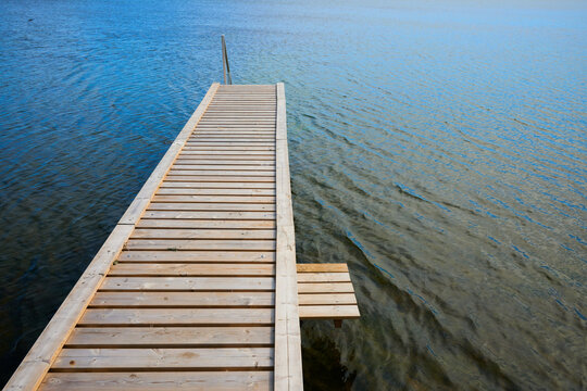 Metal stairs on a wooden terrace overlooking the sea, ideal for swimming, in Dragor, Denmark.