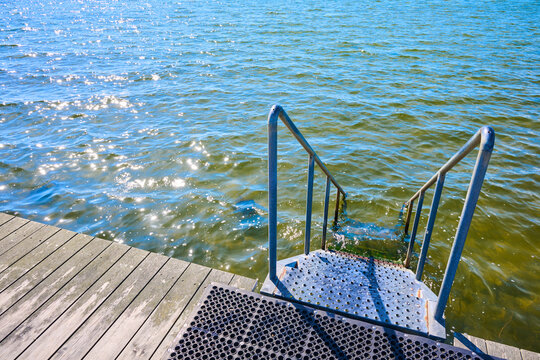 Metal stairs on a wooden terrace overlooking the sea, ideal for swimming, in Dragor, Denmark.