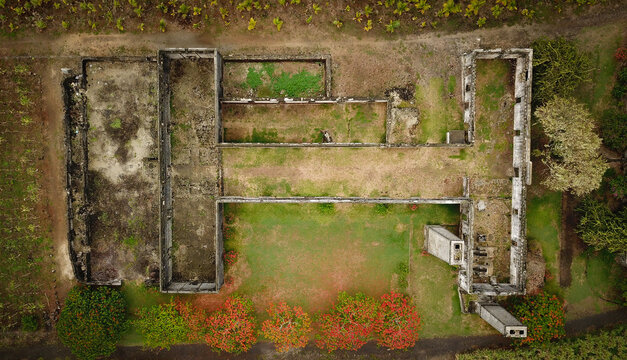 Aerial view of the historic Four a Chaux lime kiln ruins, featuring stone walls, grassy courtyards, and surrounding tropical vegetation in Quatre Cocos, Flacq, Mauritius.