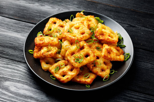 Hash Brown Waffles with Spring Onion on black plate