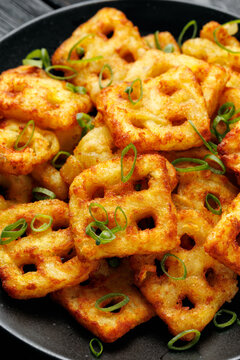 Hash Brown Waffles with Spring Onion on black plate