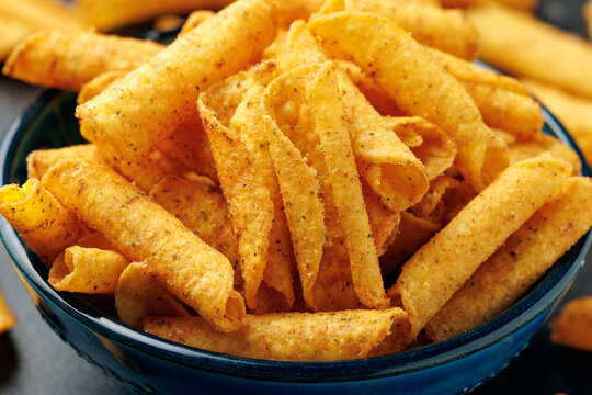 Rolled Tortilla Corn Chips in Blue Bowl on dark background