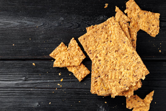 Wholegrain Cheese Crispbread with Mixed Seeds on Dark Background