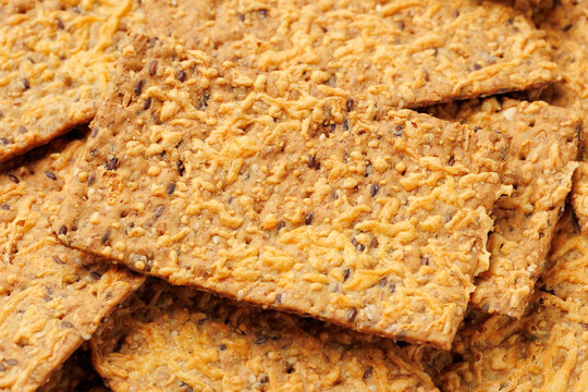 Wholegrain Cheese Crispbread with Mixed Seeds on Dark Background