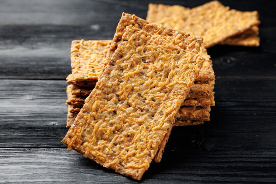 Wholegrain Cheese Crispbread with Mixed Seeds on Dark Background
