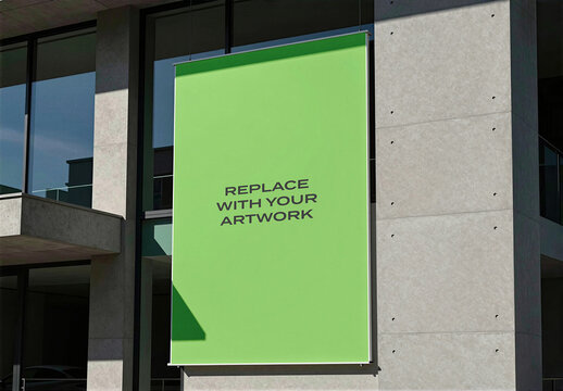 Vertical banner mockup displayed on a modern concrete building exterior with large glass windows, realistic outdoor advertising presentation commercial facade, wall signage template