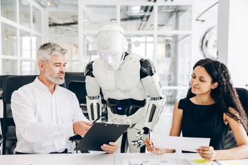 Businesspeople and robot working together in modern office