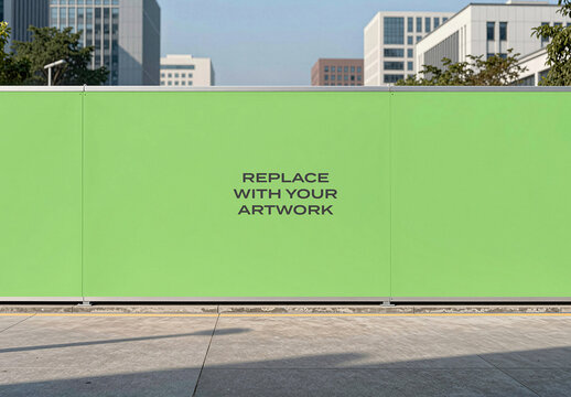 Large construction hoarding mockup with placeholder text for artwork, urban street scene featuring modern buildings and concrete pavement, outdoor advertising display in a public space