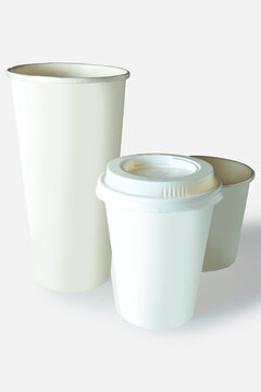 Three white and beige paper coffee cups in various sizes, one with a lid, isolated on a white background. Mockup or Copyspace