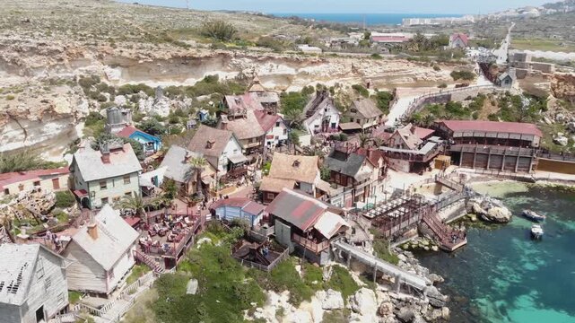 Aerial view of picturesque Popeye village theme park coastal scenery in Malta.