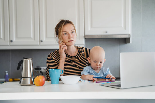 Mother balancing between work and baby on sick or maternity leave.