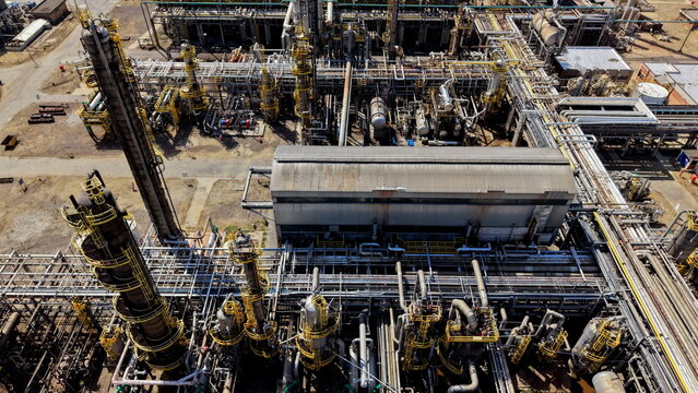 Aerial view of the petrochemicals industry featuring complex networks of industrial pipes, distillation towers, and metal structures in Pancevo, Serbia.